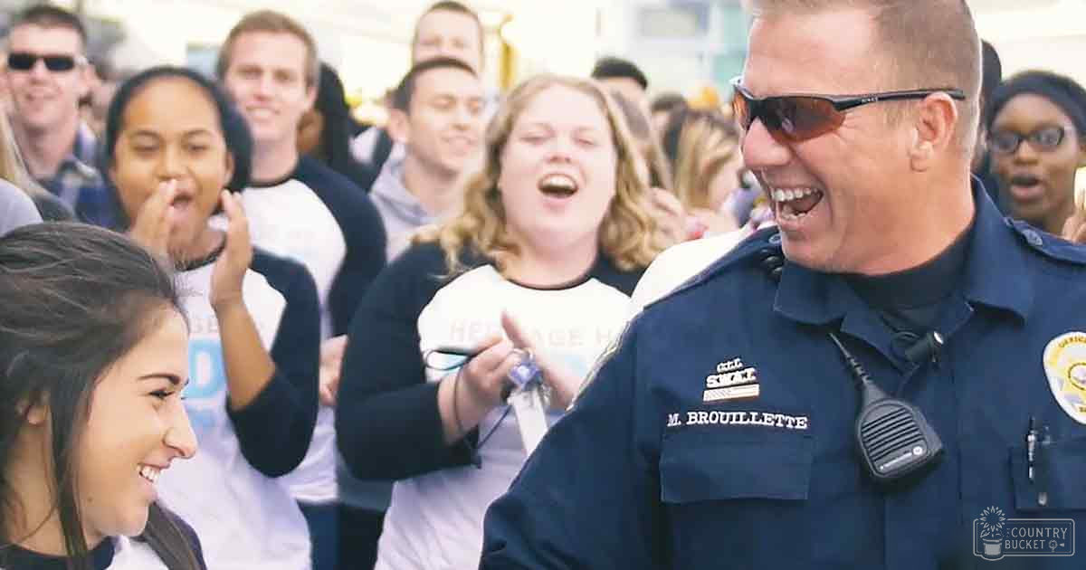A police officer interacting with a group of young adults outdoors, with a focus on their casual attire and interactions under daylight conditions.