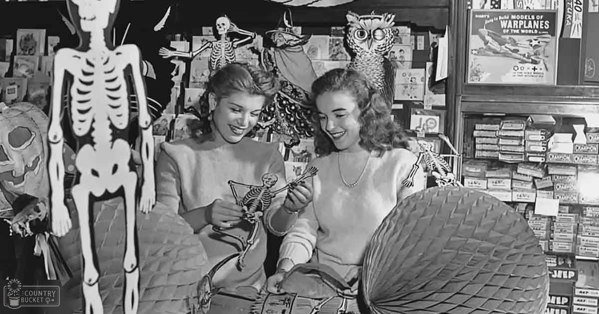 Two young adult females wearing Halloween-themed attire in a store setting filled with decorations.