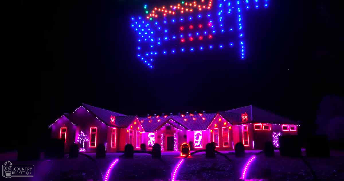 A house decorated with colorful holiday lights in an urban residential area at night.