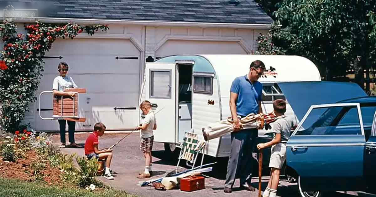 A family prepares for a trip in front of their suburban home with classic car and travel trailer, suggesting mid-20th century setting.