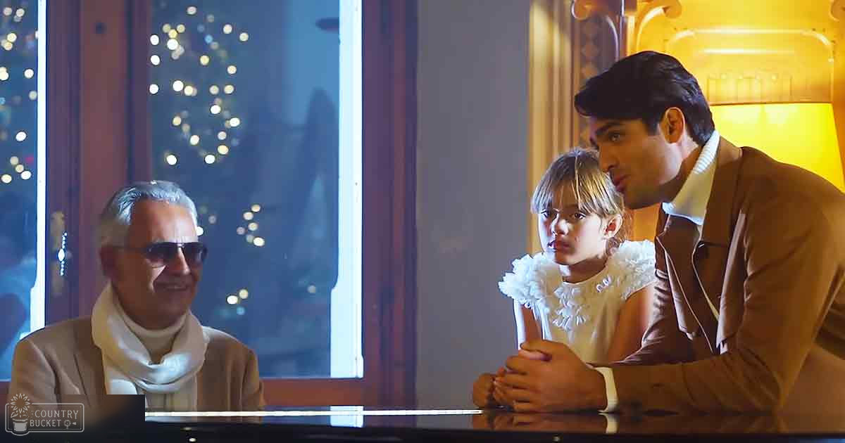 A family scene indoors in a living room with a piano visible at the bottom of the frame during nighttime around Christmas time.