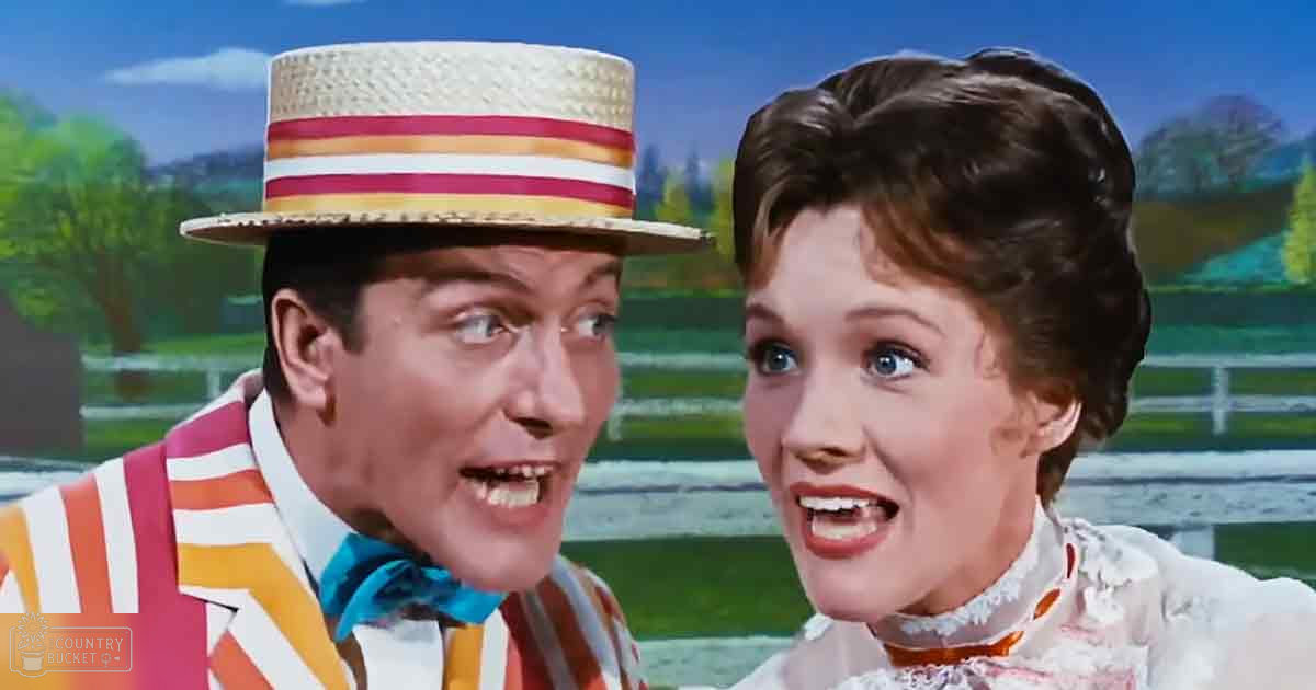 Rural countryside scene with two adults, one wearing a striped jacket and the other in a white blouse with lace details, under a clear blue sky during spring or summer.