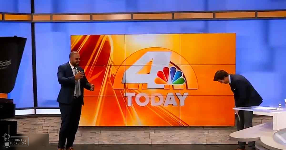 A television studio setting with two adult male news anchors in formal attire, a white table with small items, and a large screen displaying '4 TODAY' and the NBC logo.