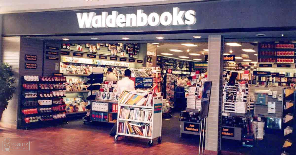 A bookstore named Waldenbooks with two individuals inside; one adult male in a white shirt, another older female in casual clothing seen through distance.