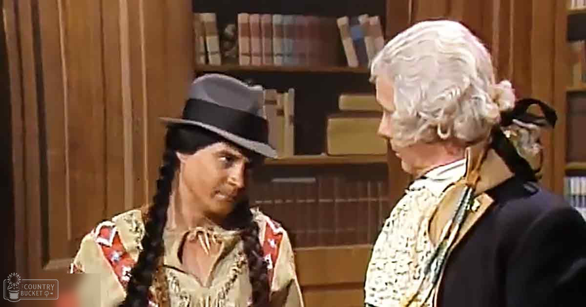 Two characters dressed in historical attire stand indoors against a backdrop of wooden-paneled walls and a bookshelf filled with books, suggesting a library or study setting. The scene is bathed in natural daylight.