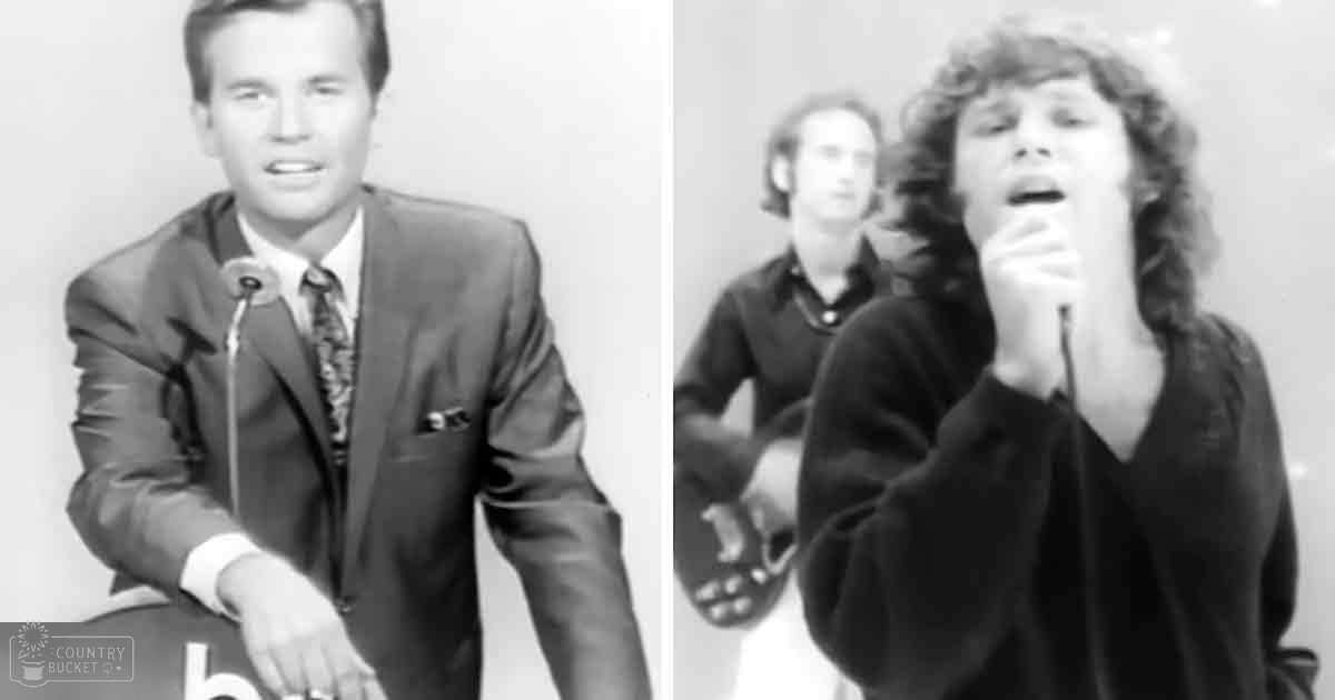 An adult male singer in a dark suit with a patterned tie and an adult male seated at a table wearing a dark sweater, both from the mid-20th century, possibly in a studio or stage setup.