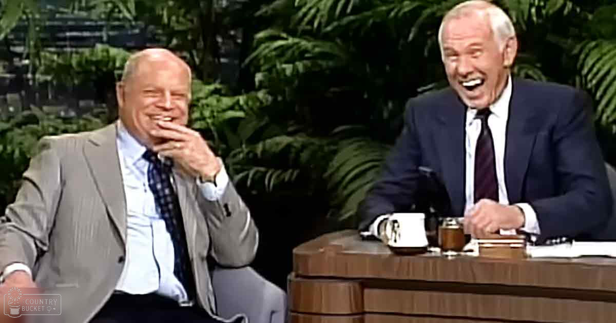 Two older men in a studio setting, wearing tailored mid-20th-century-style suits with white dress shirts and patterned ties.