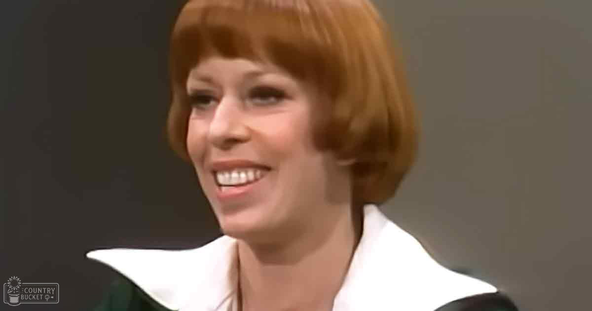 Young adult female in white high-collared blouse, mid-20th-century style, indoors with neutral walls and soft lighting.