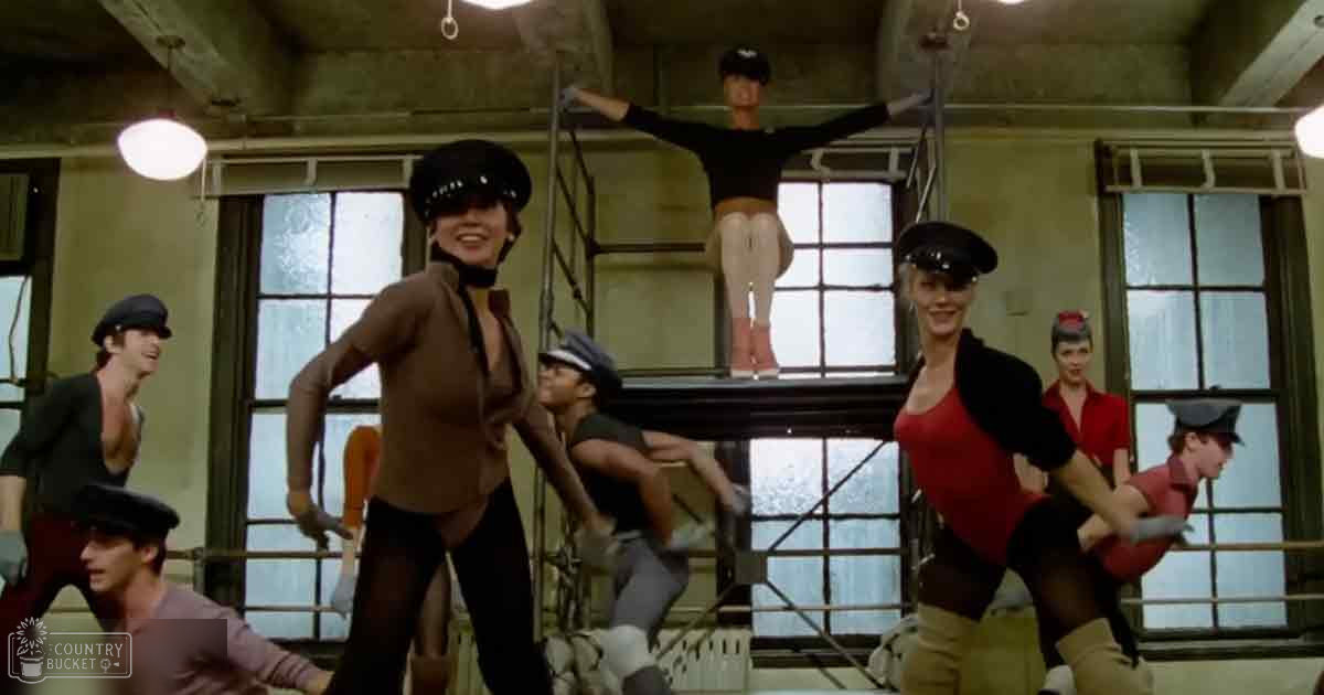 A dance routine in an urban studio setting with natural light streaming through large windows.