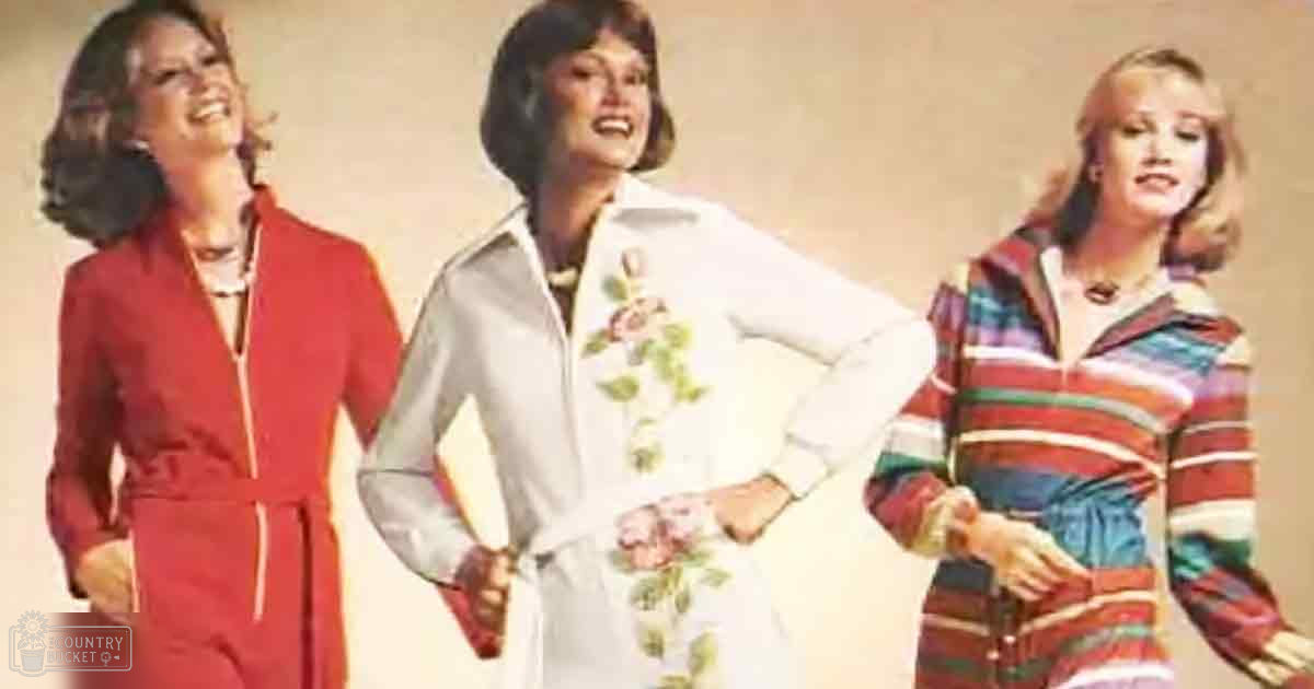 Three female models in 1970s fashion advertisements, each wearing distinct jumpsuits and dresses with vibrant colors against a plain beige studio background.