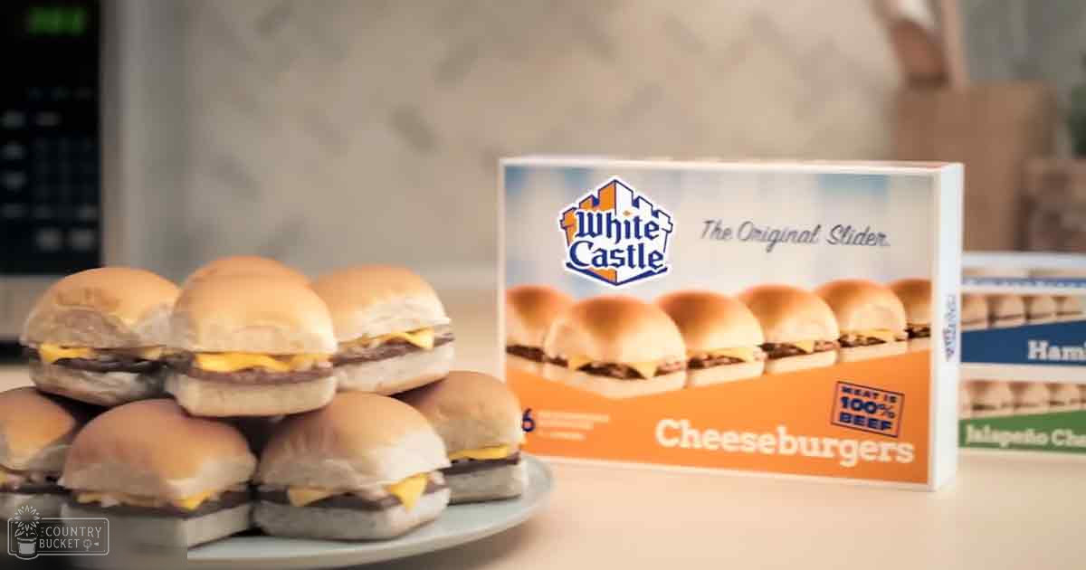 A plate of White Castle cheeseburgers sits in a kitchen setting with neutral-colored walls and countertop surfaces.