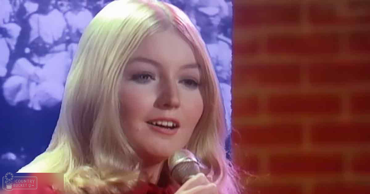 A young adult female singer wearing a red dress holding a microphone, with 'Madly Odd' text visible.