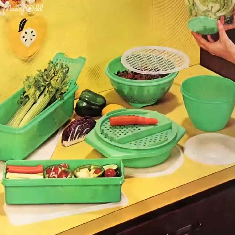 A kitchen scene with green vegetables, tools, and ingredients on a counter indoors during daytime.