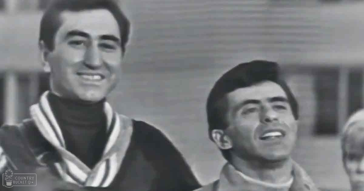 Young adult males wearing mid-20th century uniforms outdoors during daytime with natural light.
