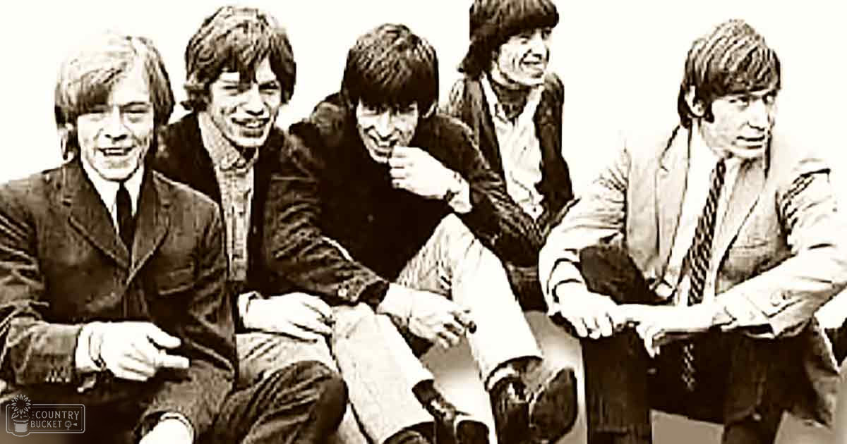 A group photo of five young adults in a studio setting with muted sepia tones.