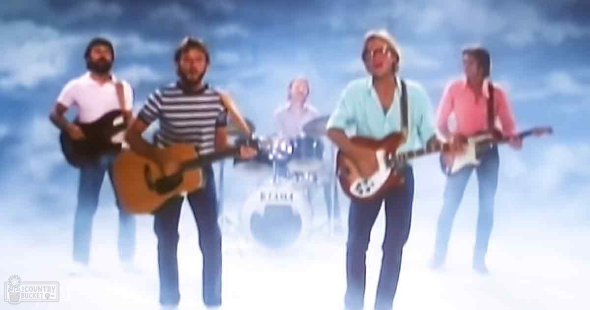 Adult males in mid-century fashion perform against an abstract blue sky with white clouds.