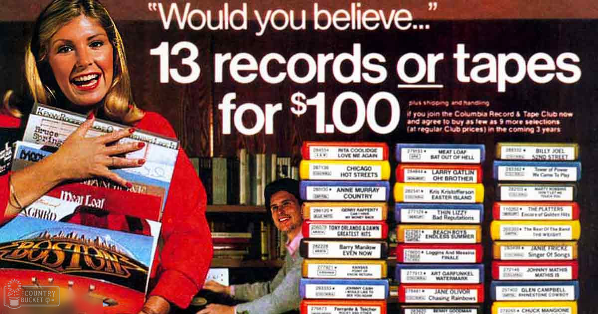 A woman holding records, wearing a red sweater with long sleeves, indoors possibly at a store or promotional area for Columbia Record & Tape Club.