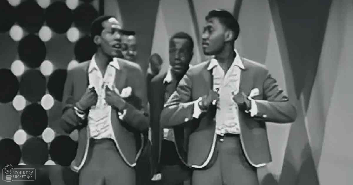 A group of young adults performing in a mid-20th-century studio setting with patterned backdrop, suggesting a professional recording or broadcasting environment.