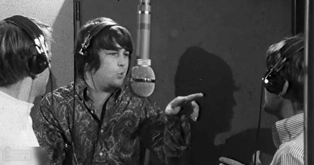 Young adult males in a recording studio wearing patterned shirts, engaging with professional audio equipment.