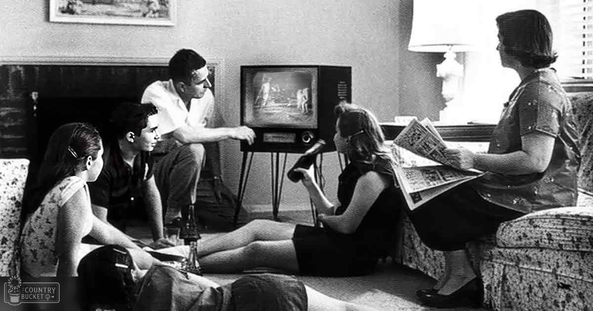 A family scene in a cozy indoor living room with a vintage television, fireplace, and natural light through the window on a winter day.