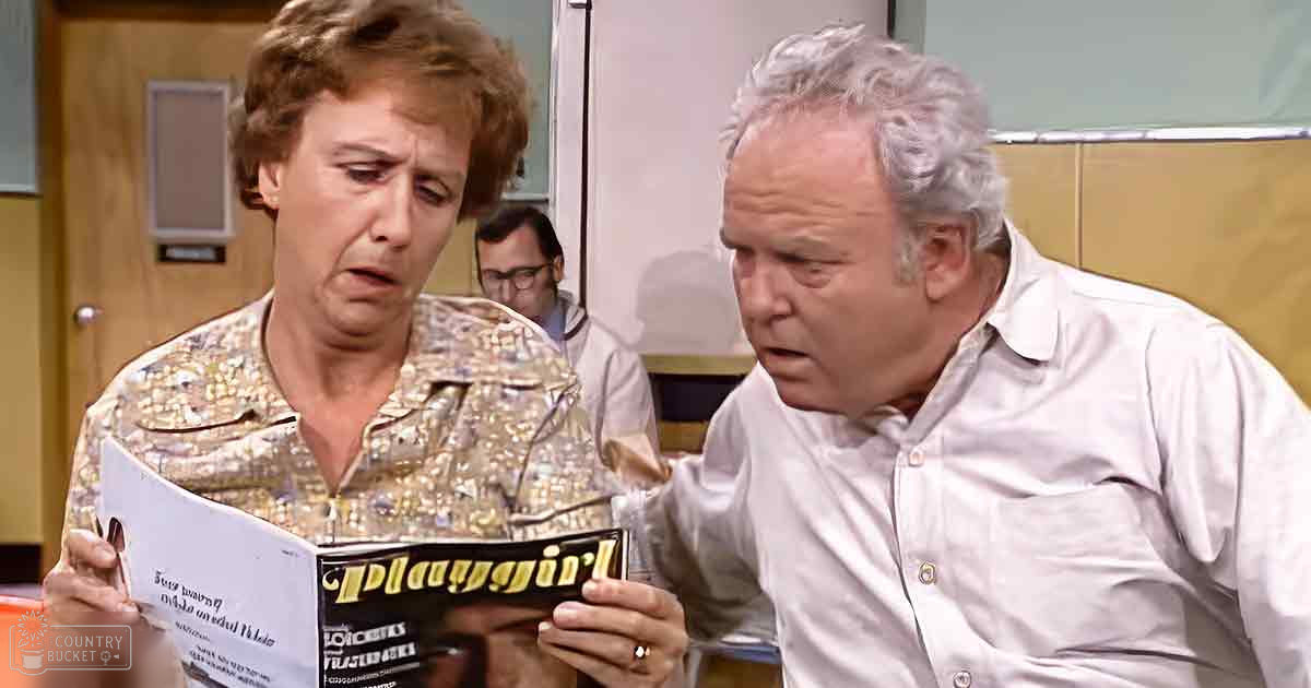 Middle-aged woman wearing a brownish-yellow patterned shirt and holding 'Playgirl', middle-aged man in an office setting with white button-up shirt, young adult male in the background wearing light blue shirt; indoor office environment from 1970s style.