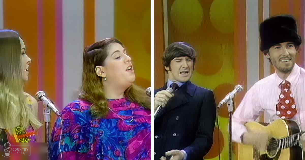 A musical performance set in a retro-style stage with bright orange and yellow stripes, colorful patterned curtains, and performers wearing vintage attire.