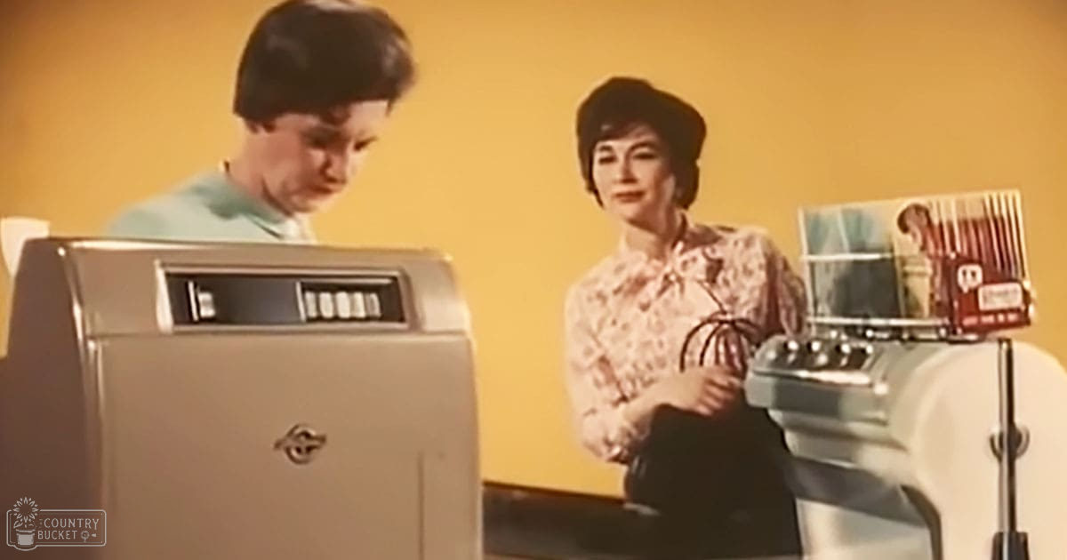 A toddler wearing a light blue shirt interacts with a vintage-style appliance in a mid-20th century home setting.