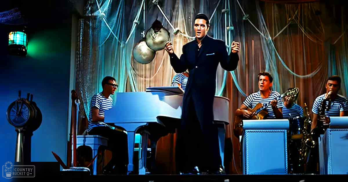 A musical performance with a central performer in a dark suit holding a microphone, surrounded by other musicians playing instruments under theatrical stage lighting.