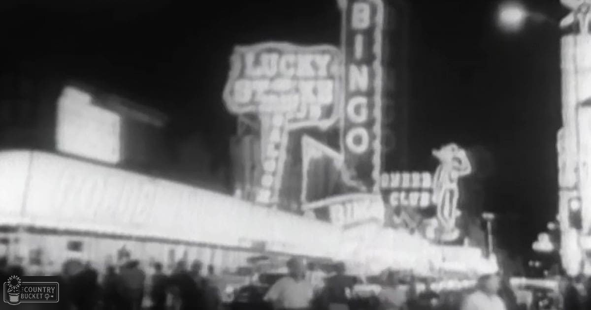 A nighttime scene at a casino or entertainment venue with neon signs for 'Lucky Bingo' displayed prominently in Las Vegas.