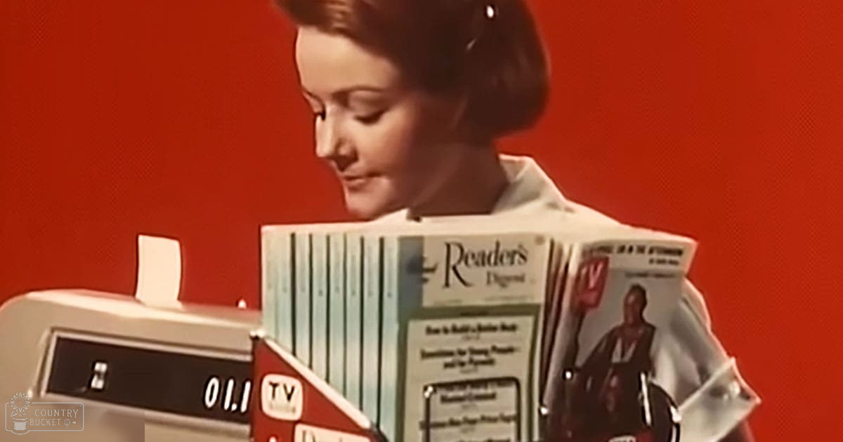 A young adult female wearing a white collared blouse stands indoors against a solid red backdrop.