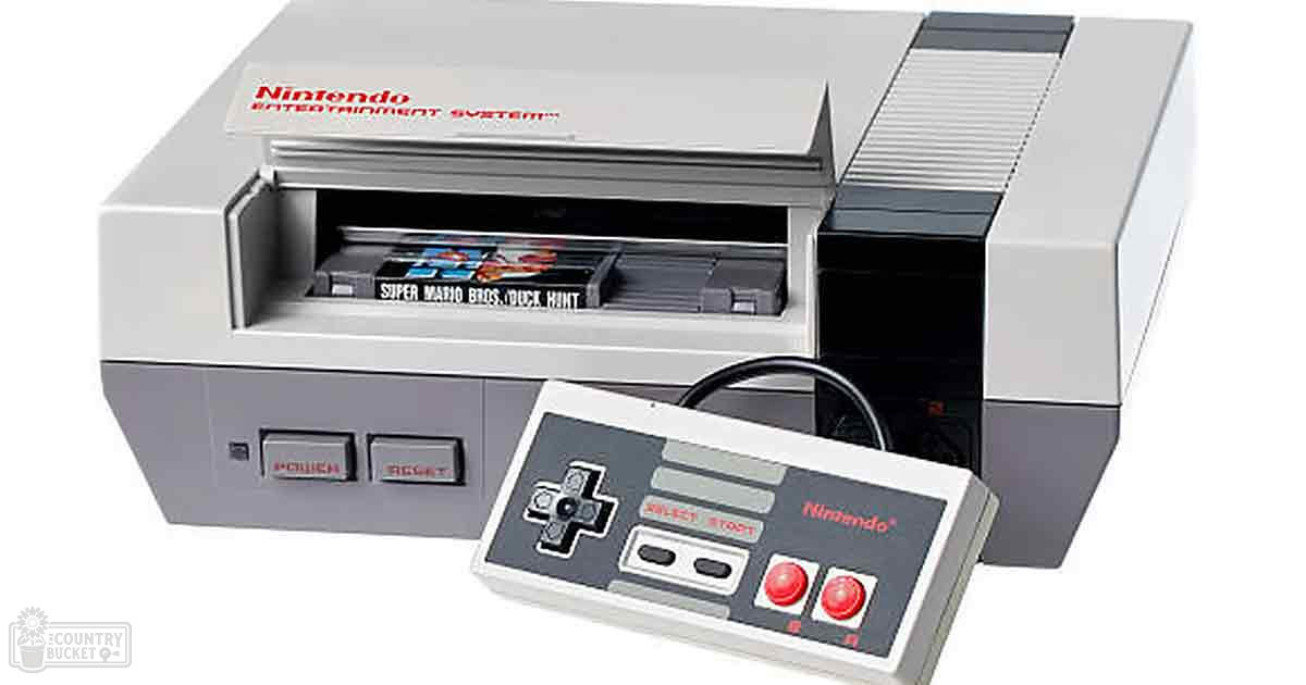Close-up of a Nintendo Entertainment System with two game cartridges inside, highlighting retro gaming equipment in an indoor setting.