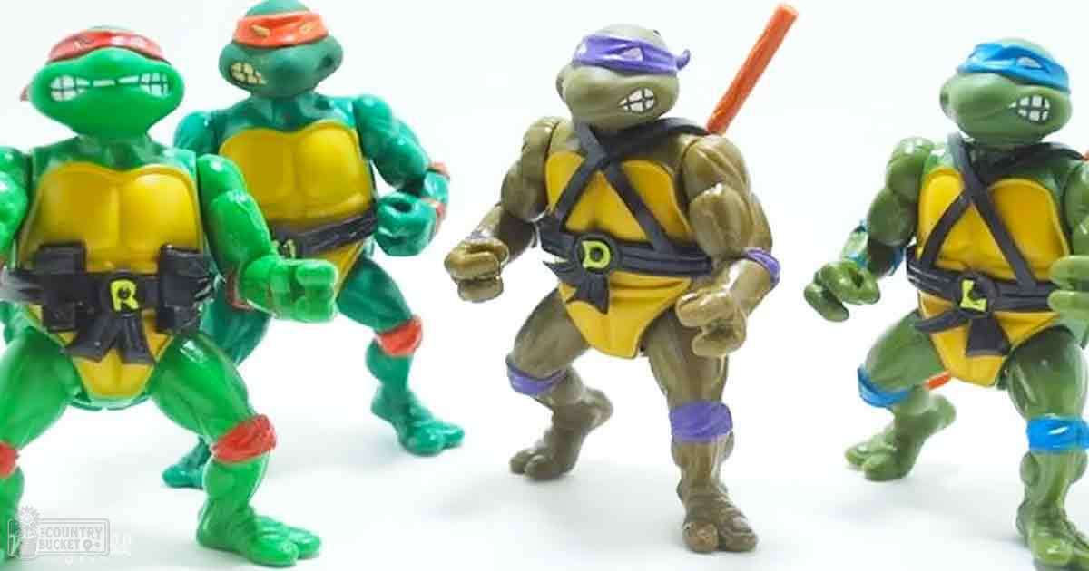 Group of Teenage Mutant Ninja Turtles action figures with distinct shells and headbands in a bright, indoor studio setting.