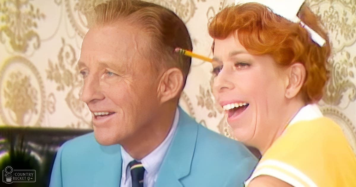 A middle-aged man and woman interacting near patterned wallpaper, suggesting an indoor setting from the mid-20th century.