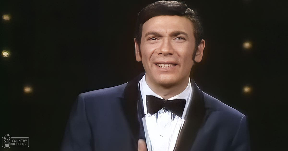 An adult male wearing a formal tuxedo with a bow tie at an indoor event.