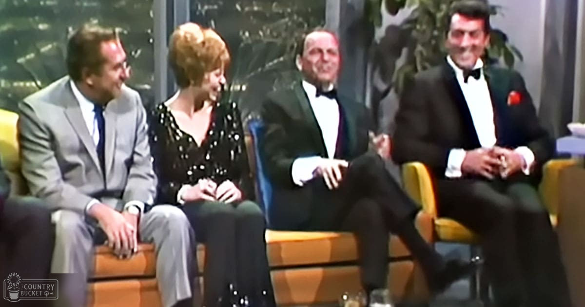 A group of adults in formal attire indoors, possibly at an event or gathering.