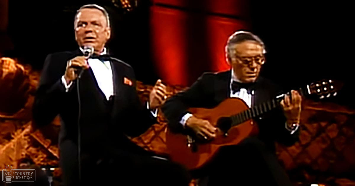 Musical performance scene with older adult male performers in formal attire on a stage with red curtains, mid-20th century ambiance.