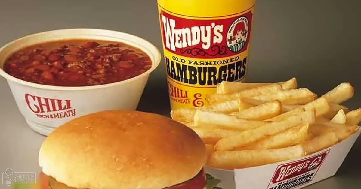 A casual dining setting with a focus on Wendy's chili, hamburgers, and fries. Visible branding includes 'Chili Rich & Meaty' and 'Old Fashioned Hamburgers'.
