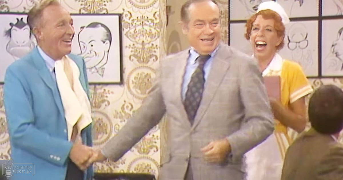 An indoor television studio or stage performance set with patterned wallpaper, framed caricatures, and a mid-20th century aesthetic.