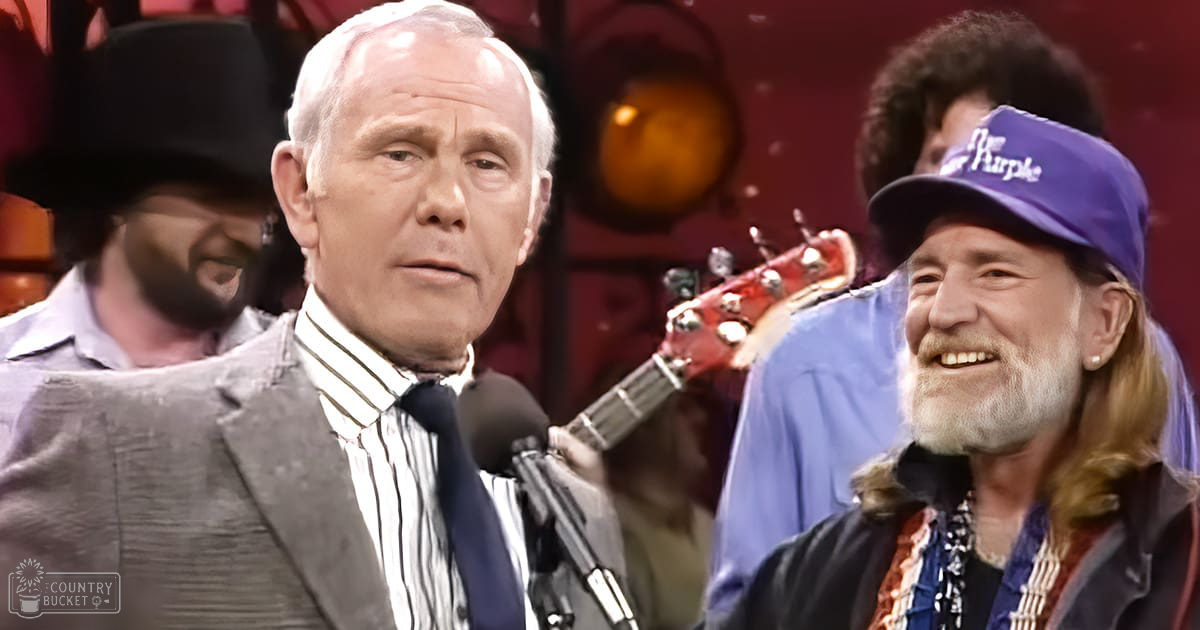 An older adult male in a performance setting with stage equipment and musical instruments visible.