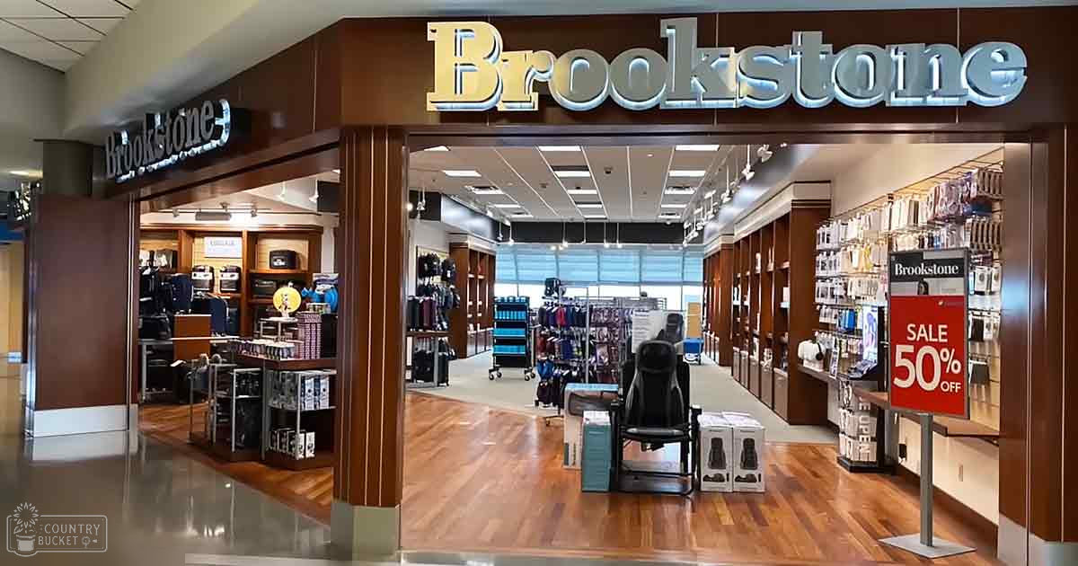 Brookstone store interior with wooden flooring and 50% off sale sign in a shopping mall.