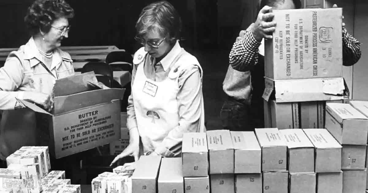 Volunteers sorting donated goods indoors at a food bank event.