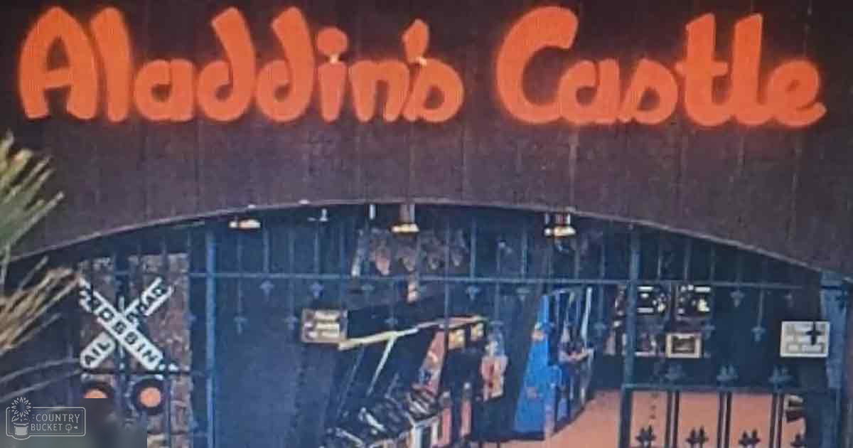Aladdin's Castle themed attraction with decorative elements, signage, and railroad crossing sign indoors.