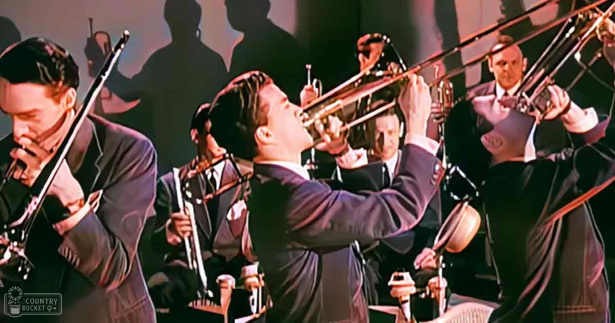 Adult males in dark suits performing jazz ensemble on a studio stage with controlled lighting.