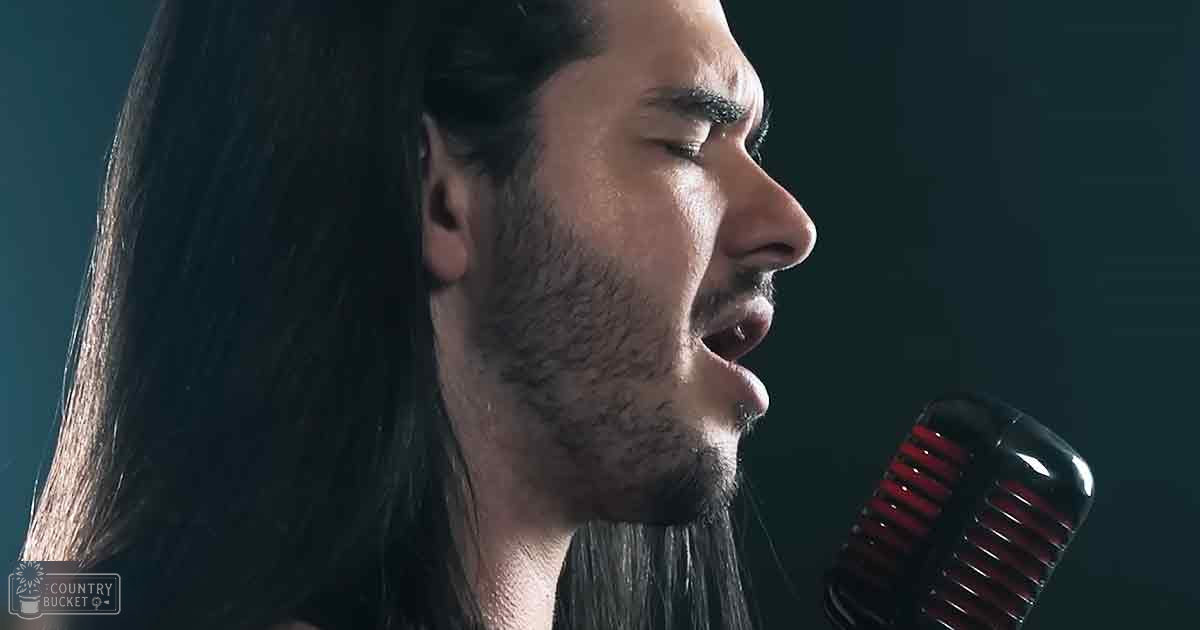 A young adult male singing into a vintage-style microphone against a dark backdrop, with 'Melodly Odd' text in the bottom left corner.