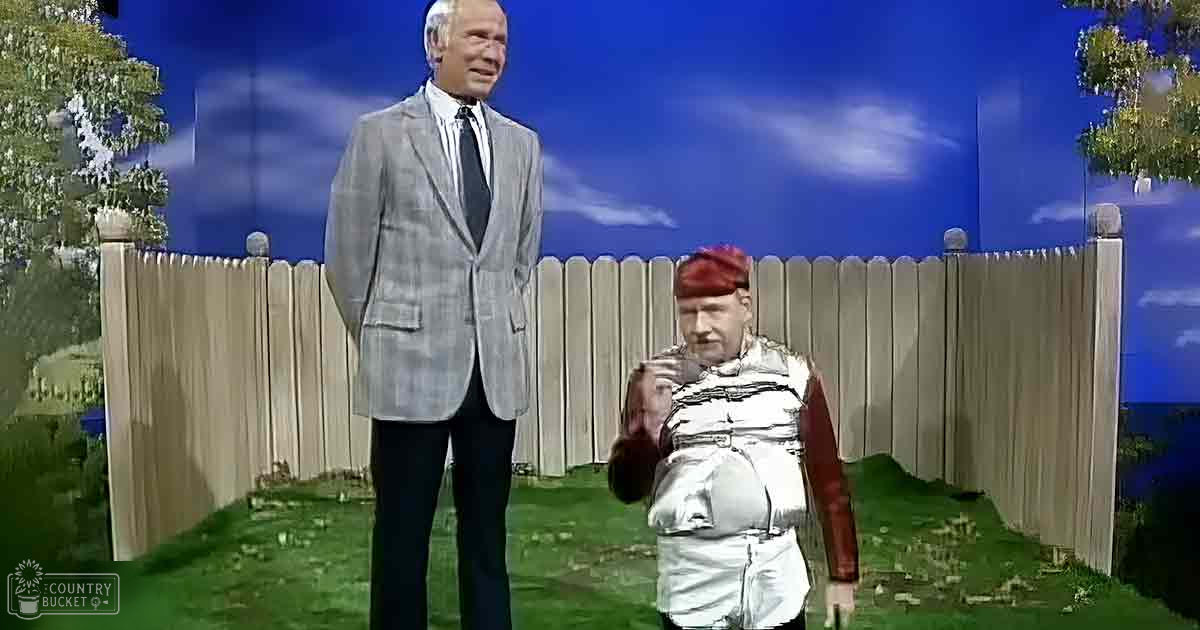 Two puppets in a backyard garden setting during the daytime with greenery and clear skies.