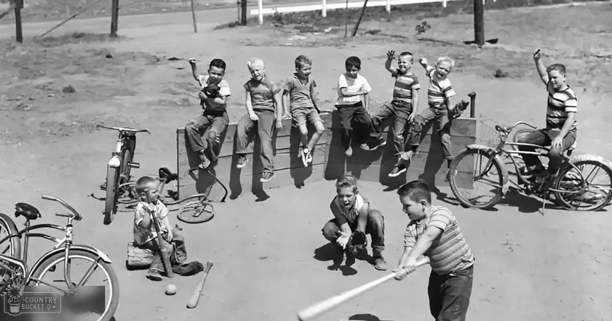 A group of children playing baseball in an outdoor setting, with some wearing striped shirts and dark pants.
