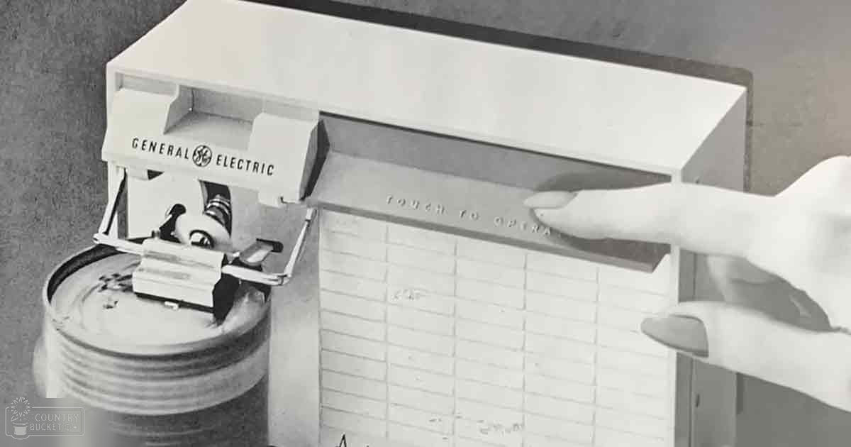 Black-and-white vintage General Electric appliance in a mid-20th century kitchen setting with neutral-colored walls and flooring.