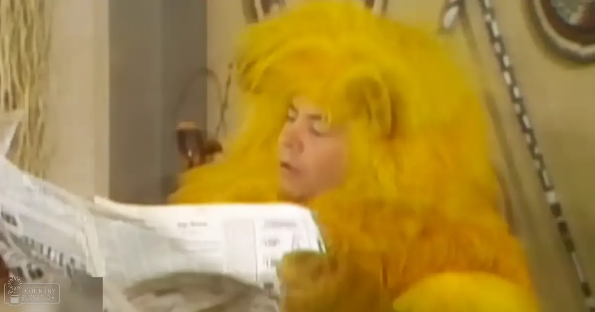 An adult female in a bright yellow fluffy wig, possibly at home holding a newspaper with a white bowl nearby.