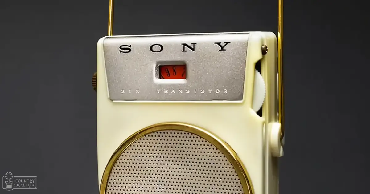 A vintage Sony Six Transistor radio with a cream-colored body, gold trim, and a silver panel displaying 'SONY' against a plain dark background.