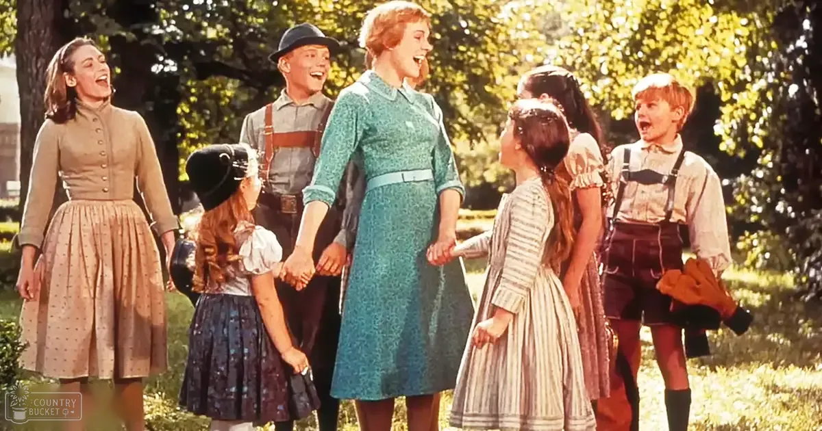 Children in a park-like setting with adults, wearing traditional outfits under soft natural light.
